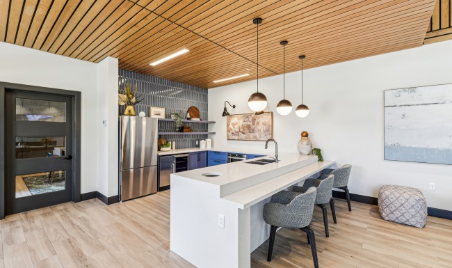 Beautiful amenities to match your lifestyle. a kitchen with a bar and a dining table